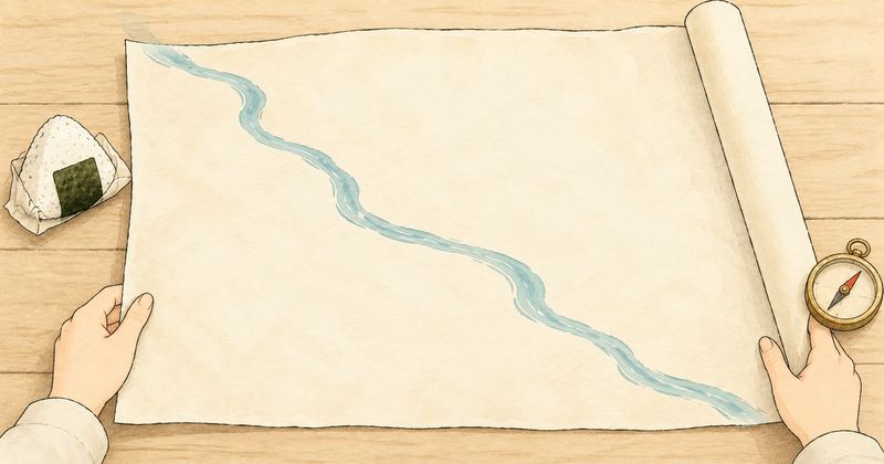 机の上に広げかけの大きな地図があり、川の線が1本だけ描かれ、両手が地図の端を押さえて広げている。